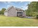 View of backyard featuring a pool and covered porch and a well-manicured lawn at 2788 Bridle Ridge Way, Buford, GA 30519