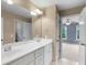 Bright bathroom features double sinks and a large mirror with views into the bedroom at 2788 Bridle Ridge Way, Buford, GA 30519