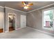 Empty bedroom with a ceiling fan, and views out of the window at 2788 Bridle Ridge Way, Buford, GA 30519