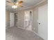 Carpeted bedroom with ensuite bathroom and several closet doors at 2788 Bridle Ridge Way, Buford, GA 30519