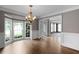 Charming dining area with hardwood floors, wainscoting, chandelier, and a large bay window at 2788 Bridle Ridge Way, Buford, GA 30519