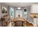 Dining area with natural light, a wood table, and an adjacent kitchen space at 2788 Bridle Ridge Way, Buford, GA 30519