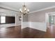 Spacious dining room boasting gleaming hardwood floors, wainscoting, and elegant chandelier at 2788 Bridle Ridge Way, Buford, GA 30519