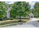 Beautiful two-story brick home with mature trees and a circular driveway at 2788 Bridle Ridge Way, Buford, GA 30519