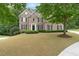 Beautiful two-story brick home featuring a manicured lawn and classic architectural details at 2788 Bridle Ridge Way, Buford, GA 30519