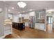 Well-designed kitchen with white cabinets, a dark island, stainless appliances, and hardwood floors at 2788 Bridle Ridge Way, Buford, GA 30519