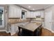 Bright kitchen with white cabinets, a dark island, granite countertops, and modern appliances at 2788 Bridle Ridge Way, Buford, GA 30519