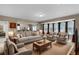 Open living room with sofas, chairs, and a rustic coffee table at 2788 Bridle Ridge Way, Buford, GA 30519
