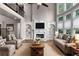 Elegant living room with fireplace, built-in shelves, soaring windows and open floorplan at 2788 Bridle Ridge Way, Buford, GA 30519