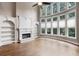 Bright and airy living area featuring fireplace, built-in shelves, and a wall of windows at 2788 Bridle Ridge Way, Buford, GA 30519