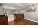 Entertainment area featuring a bar with a sink, dark cabinets and wood floors at 2788 Bridle Ridge Way, Buford, GA 30519