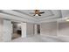 Spacious bedroom featuring tray ceilings, crown molding and access to bathroom at 2788 Bridle Ridge Way, Buford, GA 30519