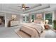 Bright main bedroom featuring a tray ceiling, fan, and neutral decor at 2788 Bridle Ridge Way, Buford, GA 30519