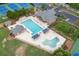 Aerial view of community pool and splash pad with lounge chairs, covered seating, and nearby tennis courts at 2788 Bridle Ridge Way, Buford, GA 30519
