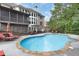 Beautiful backyard pool with a tanning ledge and stone surround offers a relaxing outdoor living space at 2788 Bridle Ridge Way, Buford, GA 30519