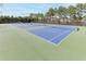 Wide angle view of well-maintained community tennis courts with benches and net systems at 2788 Bridle Ridge Way, Buford, GA 30519