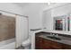 Well-lit bathroom featuring a shower-tub combo and a granite-topped vanity with dark wood cabinets at 11 Perimeter E Ctr # 1404, Atlanta, GA 30346