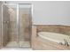Tiled bathroom showcases a shower and a soaking tub at 11 Perimeter E Ctr # 1404, Atlanta, GA 30346