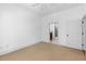 Bedroom with neutral carpet leads to a bathroom with tile flooring at 11 Perimeter E Ctr # 1404, Atlanta, GA 30346