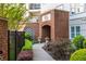 Elegant entrance to The Prescott, featuring brickwork, manicured landscaping, and refined details at 11 Perimeter E Ctr # 1404, Atlanta, GA 30346