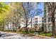 Scenic view of The Prescott condos with lush trees, landscaping, and charming architecture at 11 Perimeter E Ctr # 1404, Atlanta, GA 30346