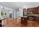 Open kitchen featuring granite countertops, an island, stainless appliances, and hardwood floors at 11 Perimeter E Ctr # 1404, Atlanta, GA 30346
