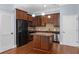 Kitchen area showcasing stainless appliances, granite countertops, wood cabinets, and an island at 11 Perimeter E Ctr # 1404, Atlanta, GA 30346