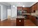 Kitchen featuring granite countertops, wood cabinets, stainless appliances, and hardwood floors at 11 Perimeter E Ctr # 1404, Atlanta, GA 30346