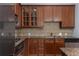 A kitchen featuring stainless steel appliances, wooden cabinets, and granite countertops at 11 Perimeter E Ctr # 1404, Atlanta, GA 30346