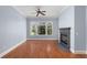 A bright living room featuring a fireplace, large windows, and hardwood floors at 11 Perimeter E Ctr # 1404, Atlanta, GA 30346