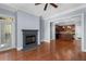 Open-concept living room with fireplace, hardwood floors, and kitchen view at 11 Perimeter E Ctr # 1404, Atlanta, GA 30346