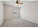 Bedroom has neutral carpet, ceiling fan, and natural light at 1575 April Ln, Morrow, GA 30260