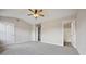 Open, airy bedroom has neutral carpet, ceiling fan, and access to ensuite bathroom at 1575 April Ln, Morrow, GA 30260