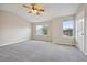 Spacious bedroom with neutral carpet, ceiling fan, and two large windows that provide ample natural light at 1575 April Ln, Morrow, GA 30260