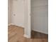 View of open closet with shelves, next to a closed door at 1575 April Ln, Morrow, GA 30260
