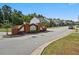 Entrance to the Southlake Townhomes community on a sunny day at 1575 April Ln, Morrow, GA 30260