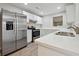Bright kitchen features stainless steel appliances, white cabinets, and quartz countertops at 1575 April Ln, Morrow, GA 30260