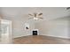 Bright living room features hardwood floors, a cozy fireplace, and a ceiling fan at 1575 April Ln, Morrow, GA 30260