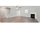 Bright living room features hardwood floors, a cozy fireplace, and a staircase at 1575 April Ln, Morrow, GA 30260