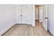 Bedroom with light hardwood floors, closet, and a view into the hallway at 2620 Mackintosh Ct # 19, Brookhaven, GA 30319