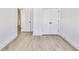 Bedroom with light hardwood floors, closet, and a view into the hallway at 2620 Mackintosh Ct # 19, Brookhaven, GA 30319