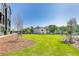 Neighborhood scene with grassy area and newly planted trees at 2620 Mackintosh Ct # 19, Brookhaven, GA 30319