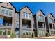 Three-story townhouse showing dark brick, lots of windows, and private balconies at 2620 Mackintosh Ct # 19, Brookhaven, GA 30319