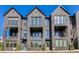 View of the townhouse-style home boasting dark brick, multiple windows, and private balconies at 2620 Mackintosh Ct # 19, Brookhaven, GA 30319