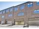 Brick townhouse featuring multiple windows and garage doors at 2620 Mackintosh Ct # 19, Brookhaven, GA 30319