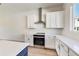 Bright kitchen features white cabinets, stainless steel appliances, and white subway tile backsplash at 2620 Mackintosh Ct # 19, Brookhaven, GA 30319