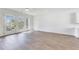 Spacious living room featuring neutral walls, hardwood flooring, and access to outdoor balcony at 2620 Mackintosh Ct # 19, Brookhaven, GA 30319