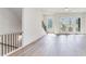 Open living room with hardwood floors, natural light, and stairway with wooden handrail at 2620 Mackintosh Ct # 19, Brookhaven, GA 30319