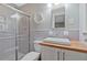 Bright bathroom featuring tiled shower, modern sink with wood counter, and updated fixtures at 3658 Brock Rd, Duluth, GA 30096