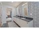 Bright bathroom with double vanity, stylish mirrors, and patterned wallpaper at 3658 Brock Rd, Duluth, GA 30096